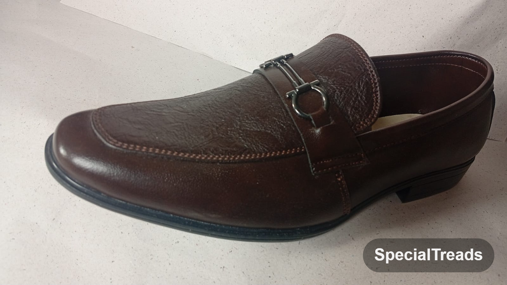 Dark brown embossed horsebit loafer close-up of hardware and texture