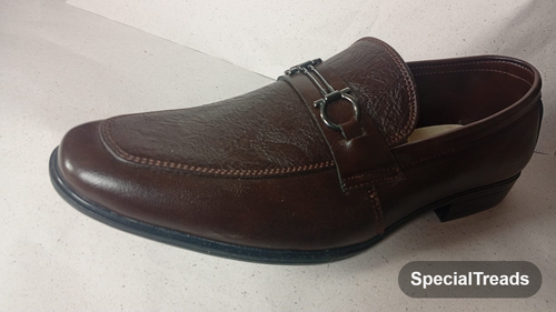 Dark brown embossed horsebit loafer close-up of hardware and texture