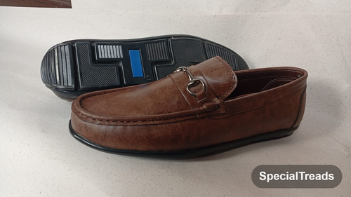 Brown horsebit loafer showing sole and upper view