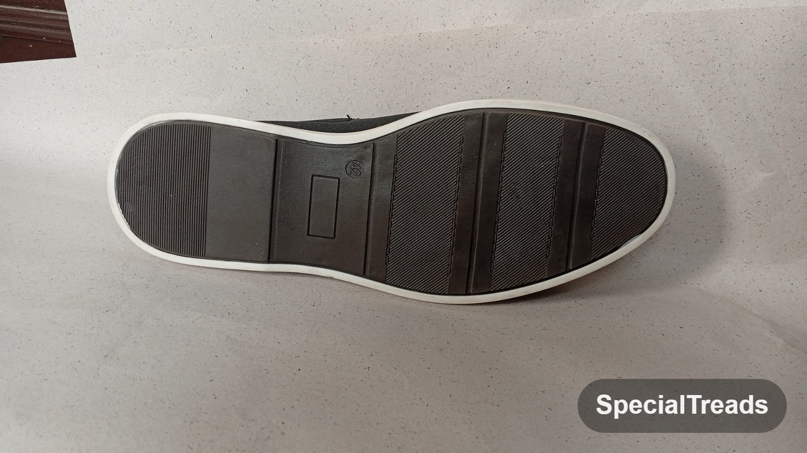 Navy suede slip-on loafer sole view showing grip pattern