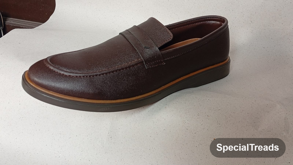 Dark brown penny loafer with tan welt and saddle strap
