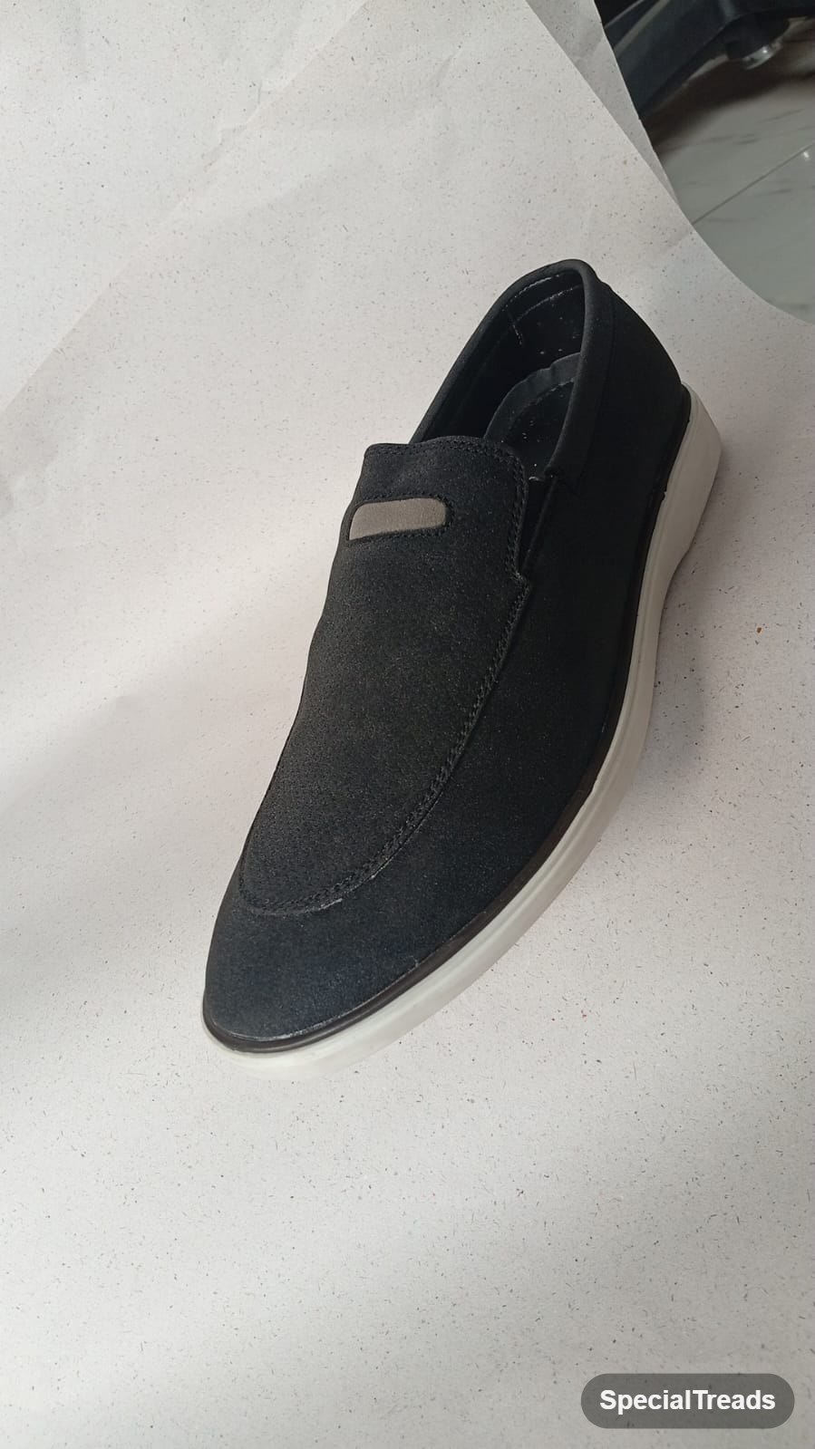 Navy suede slip-on loafer angled front view