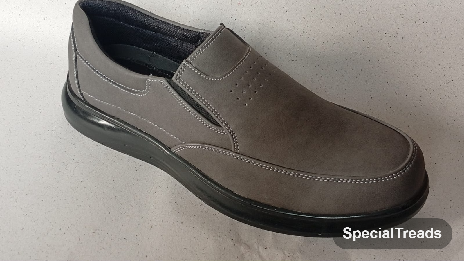 Taupe nubuck comfort slip-on loafer with perforated vamp and chunky black sole