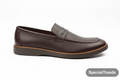 Dark brown penny loafer side profile on white background