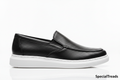 Black perforated loafer side profile on white background