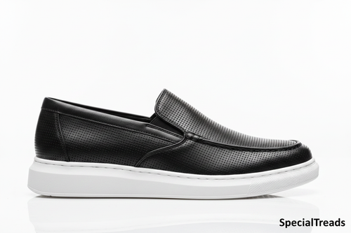 Black perforated loafer side profile on white background